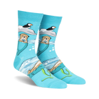 Crew socks in teal featuring otters holding flowers, puffins on ice floes, and an ocean scene. Made with space dye yarn.