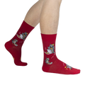 Lifestyle shot of a person's legs wearing the red Trash Panda socks.