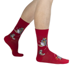 Lifestyle shot of a person's legs wearing the red Trash Panda socks.