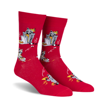 pair of red socks with raccoons eating pizza. the socks have a black and white illustration of a raccoon eating pizza from a box, with a design that repeats across the entire sock. the socks are lying flat on a white background.  a full side view of the socks.