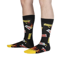 Lifestyle shot showing the 'Extra Hot' socks on a person's legs. The socks' design is clearly visible.