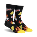 Pair of black crew socks with a playful design of flaming hot sauce packets and yellow flames.  'HOT!' text is visible on some packets.