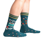 Lifestyle shot of a person wearing teal 'Take A Trip' socks, showcasing the socks on the feet.