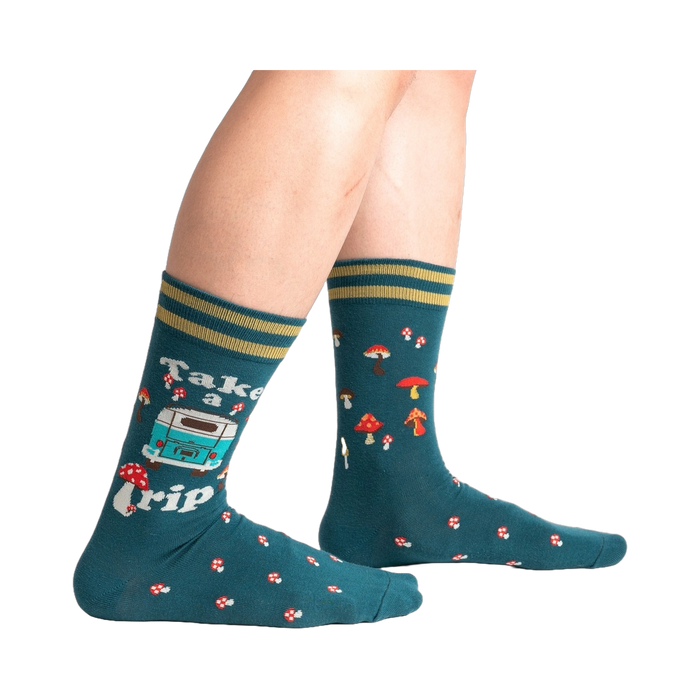 Lifestyle shot of a person wearing teal 'Take A Trip' socks, showcasing the socks on the feet.