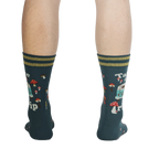 Rear view of a person wearing the teal 'Take a Trip' socks, displaying the back design