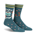 Pair of teal crew socks with a retro camper van, mushrooms, and the text 'Take a Trip'. Yellow and green stripes at the cuff.