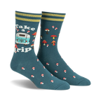 Pair of teal crew socks with a retro camper van, mushrooms, and the text 'Take a Trip'. Yellow and green stripes at the cuff.
