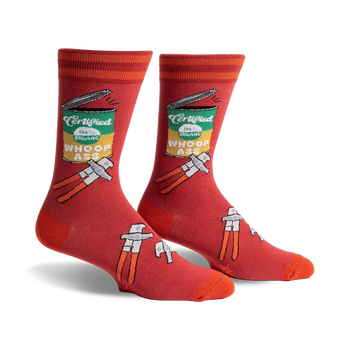 red crew socks with orange stripes and a can opener design opening a can of "certified 100% organic whoop ass."  