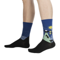 Lifestyle shot showing The Starry Flight socks on a person's legs, highlighting the fit and design.