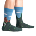 Lifestyle shot of 'Bucket List' socks on a person's legs, showing the socks' fit and design.