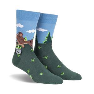 mens crew socks in blue, brown, and green featuring a big foot creature sitting on a log drinking a beer.   