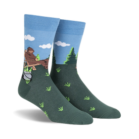 mens crew socks in blue, brown, and green featuring a big foot creature sitting on a log drinking a beer.   