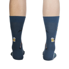Rear view of Brew-Dolph socks on a person's legs, highlighting the full design on the back.