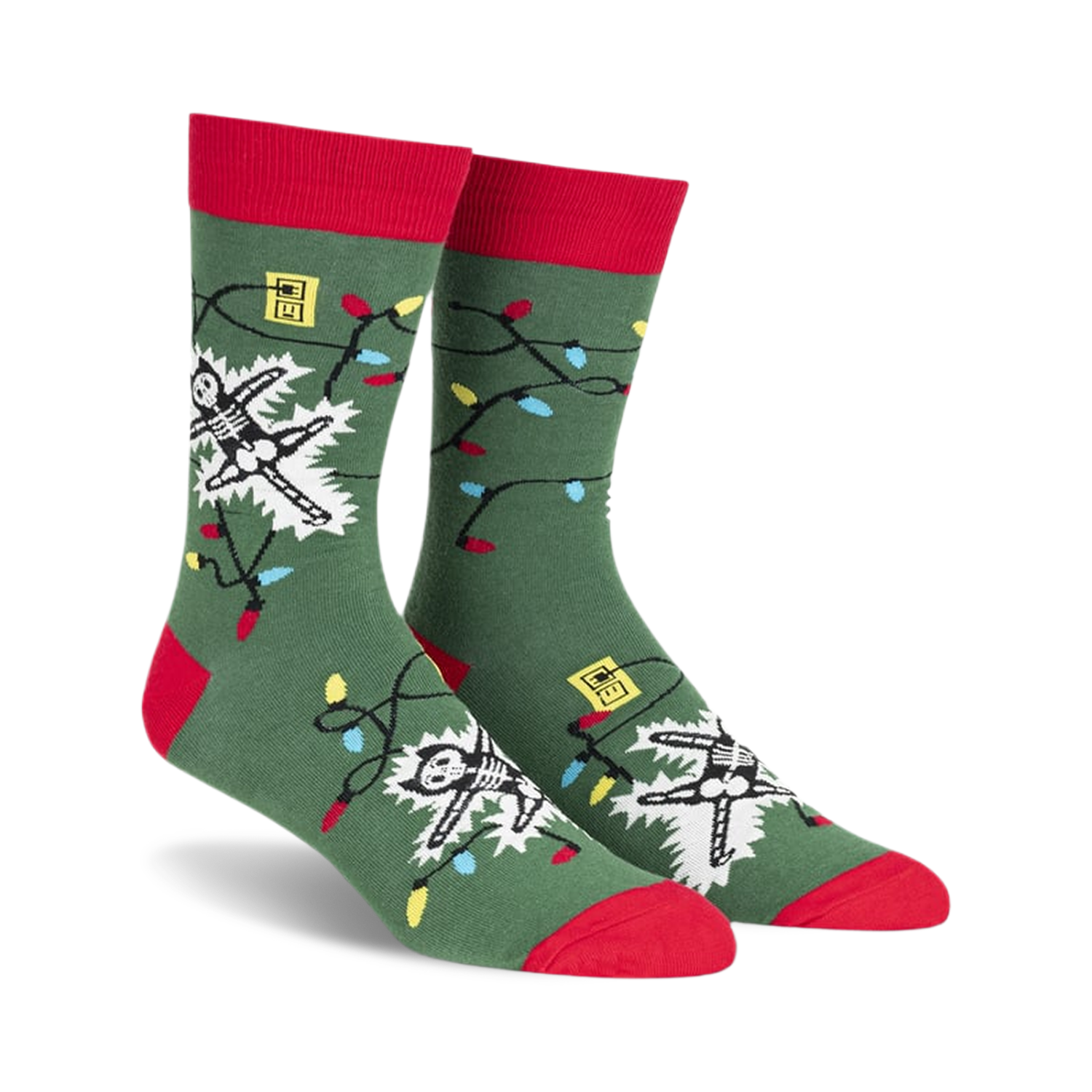Crew socks in green with red cuffs, featuring a skeleton tangled in colorful Christmas lights.  The design glows in the dark!