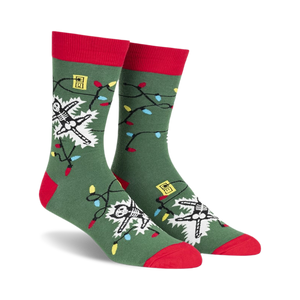 front view of a pair of green socks with red cuffs. the socks feature a white skeleton entangled in christmas lights.  the lights are red, yellow, blue, and green.