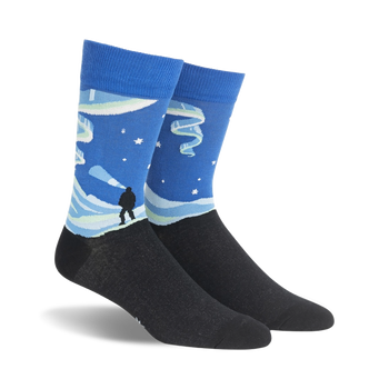 blue crew socks with aurora borealis, mountains, and person imagery. mens sizes.  