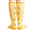Rear view of the yellow bee socks, highlighting the honeycomb design on the back.