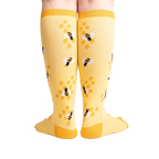 Rear view of the yellow bee socks, highlighting the honeycomb design on the back.