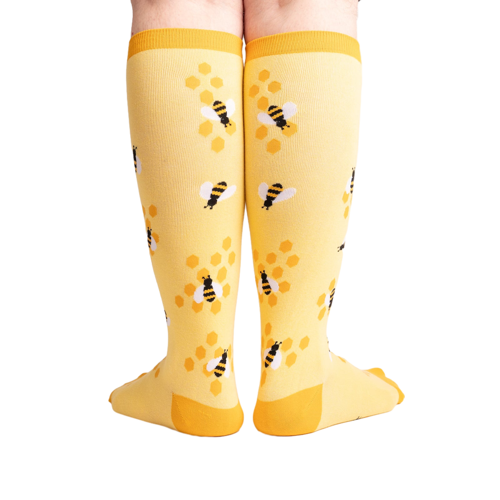 Rear view of the yellow bee socks, highlighting the honeycomb design on the back.