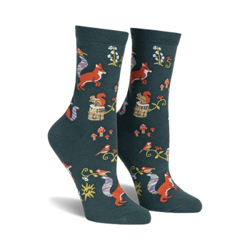 woodland-themed novelty socks with red, orange, and white foxes, red and white mushrooms, pink, yellow, and blue flowers, and blue, yellow, and white birds.  