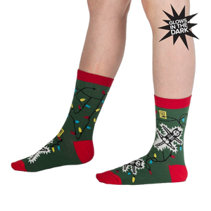 Lifestyle shot of a person modeling the 'Eating Light' socks, showcasing the glow-in-the-dark feature.