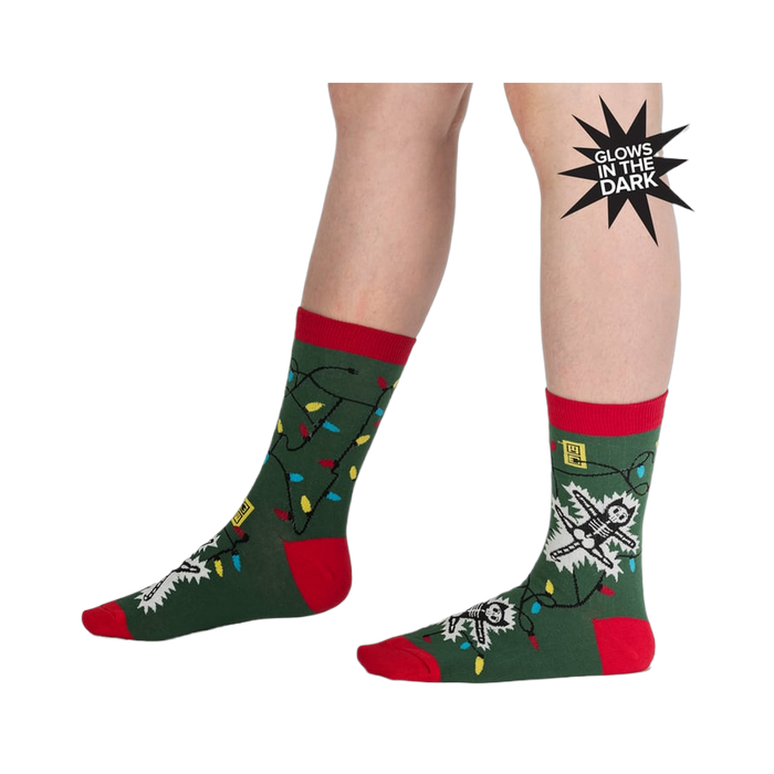 Lifestyle shot of a person modeling the 'Eating Light' socks, showcasing the glow-in-the-dark feature.