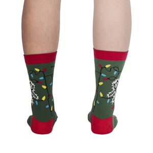 Back view of the 'Eating Light' socks on a model's legs, showing the full design.