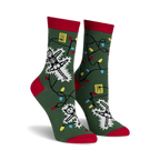 Crew socks in green with red cuffs, featuring skeletons tangled in colorful Christmas lights.  Glows in the dark!