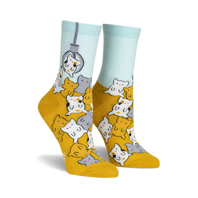 socks with a pattern of cats in claw vending machine grabbers. the cats are multi-colored and the background is yellow. socks that are mostly yellow and have a light blue cuff.