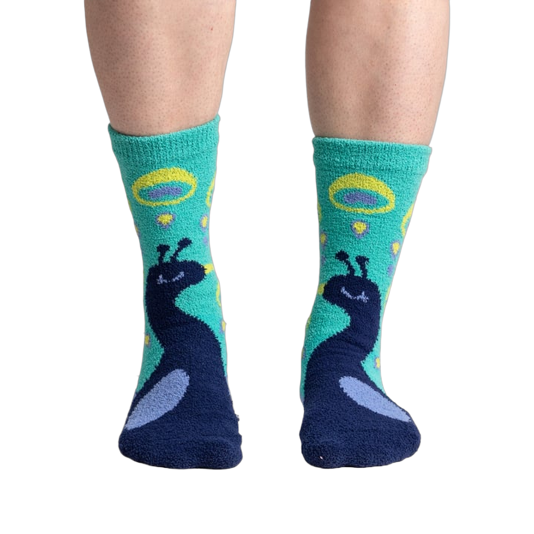 Close-up shot of 'I'm Your Biggest Fan' slipper socks on a person's feet, showcasing the teal and navy peacock design.