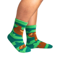 Lifestyle photo showing the socks on a person's feet.  The socks are teal and green with brown sloths.