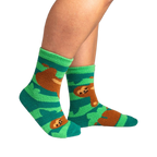Lifestyle photo showing the socks on a person's feet.  The socks are teal and green with brown sloths.