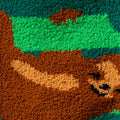 Close-up detail shot of the fuzzy sock texture and a brown sloth design.