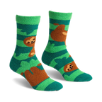 Pair of teal and green fuzzy slipper socks with brown sloths hanging from branches. Crew-length socks with grippers on the bottom.