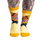 Lifestyle shot of a person wearing the yellow butterfly slipper socks, showcasing the fit and feel.