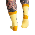Back view of the yellow butterfly socks; highlighting the mustard yellow cuff and heel.