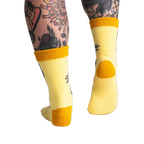 Back view of the yellow butterfly socks; highlighting the mustard yellow cuff and heel.