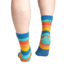 Back view of the socks on feet, highlighting the grippy bottom.