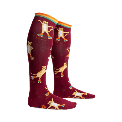 burgundy knee-high socks with a pattern of yellow cartoon cats wearing roller skates. women's socks.  