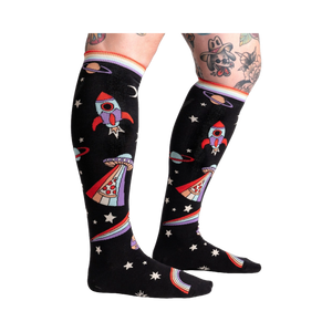 Close-up of 'You Are Outta This World' knee-high socks on a model's legs, showcasing the design.