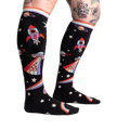 Close-up of 'You Are Outta This World' knee-high socks on a model's legs, showcasing the design.