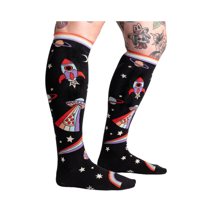 Close-up of 'You Are Outta This World' knee-high socks on a model's legs, showcasing the design.