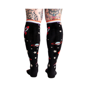 Back view of the socks on a model's legs, showing the full sock pattern.