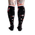 Back view of the socks on a model's legs, showing the full sock pattern.