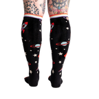 Back view of the socks on a model's legs, showing the full sock pattern.