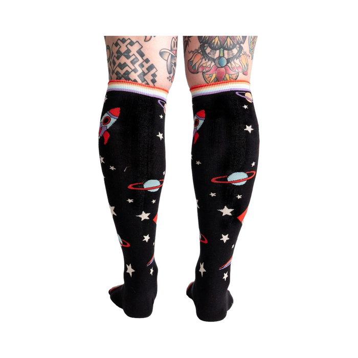 Back view of the socks on a model's legs, showing the full sock pattern.