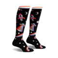 Pair of black knee-high socks with rockets, aliens, pizza slices, rainbows, and stars. Colorful, playful design.