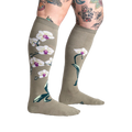 Lifestyle shot showcasing Orchid knee-high socks on a model with tattoos, highlighting the socks' length and design.