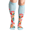 Lifestyle shot showcasing the Wonderland Mushrooms knee-high socks on a model's legs.