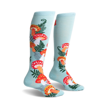 light blue knee-high socks with all-over pattern of red and orange mushrooms, white spots, green ferns.  